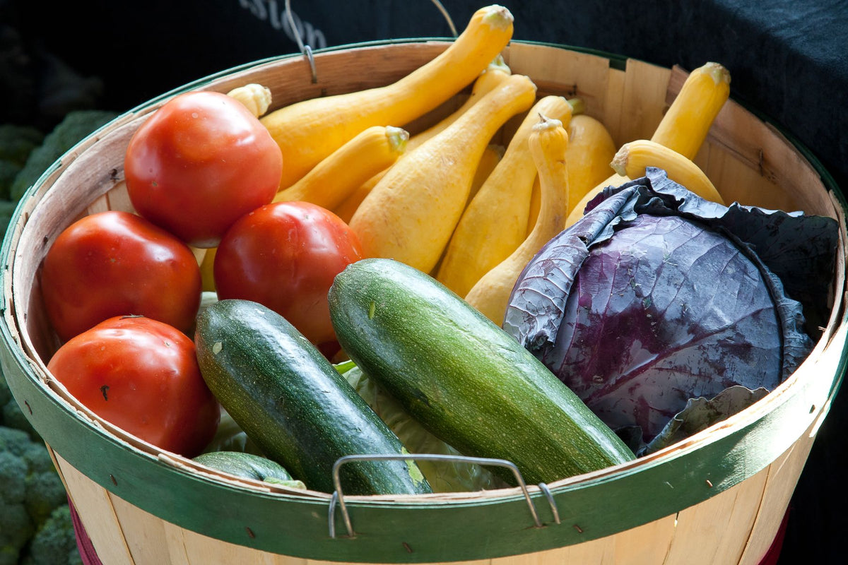 Basket bhara mixed vegetables - tamatar, squash, zucchini, patta gobhi - representing variety seed kit